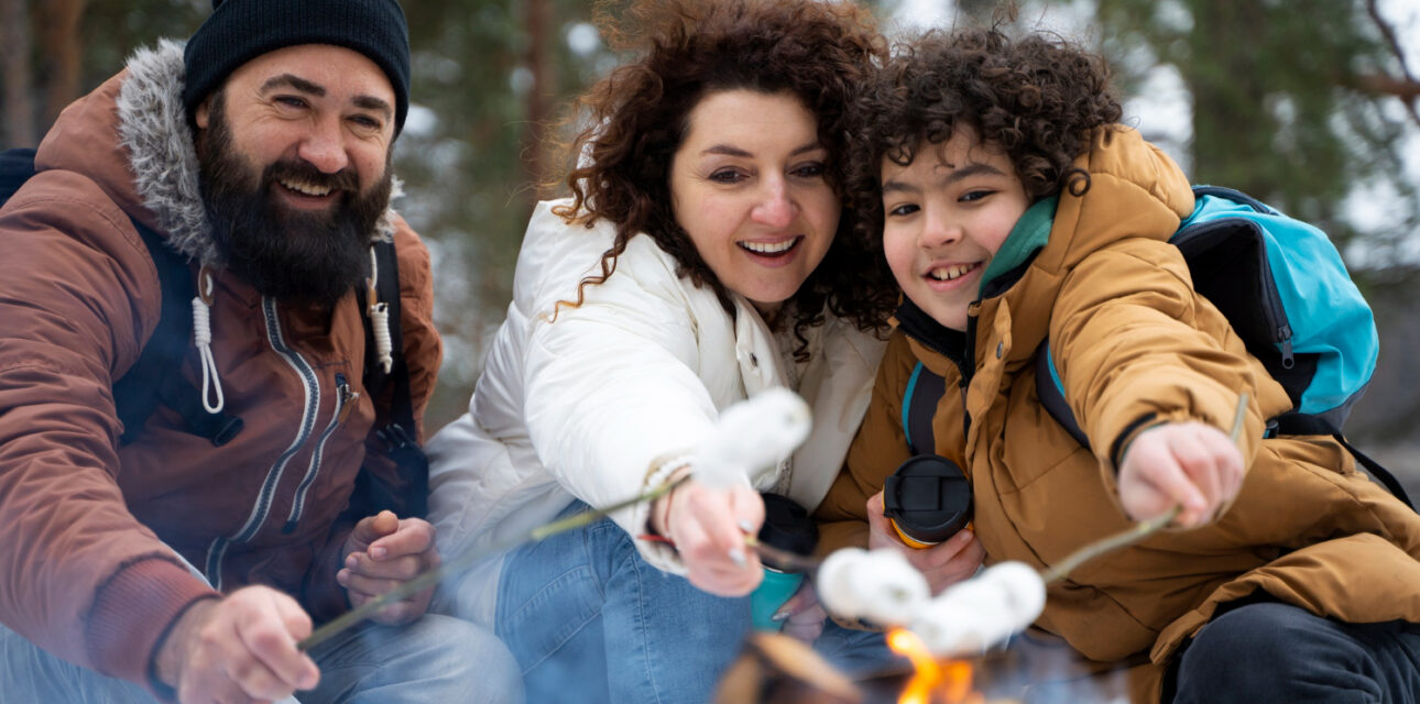 Family roasting marshmallows over a campfire in Colorado.