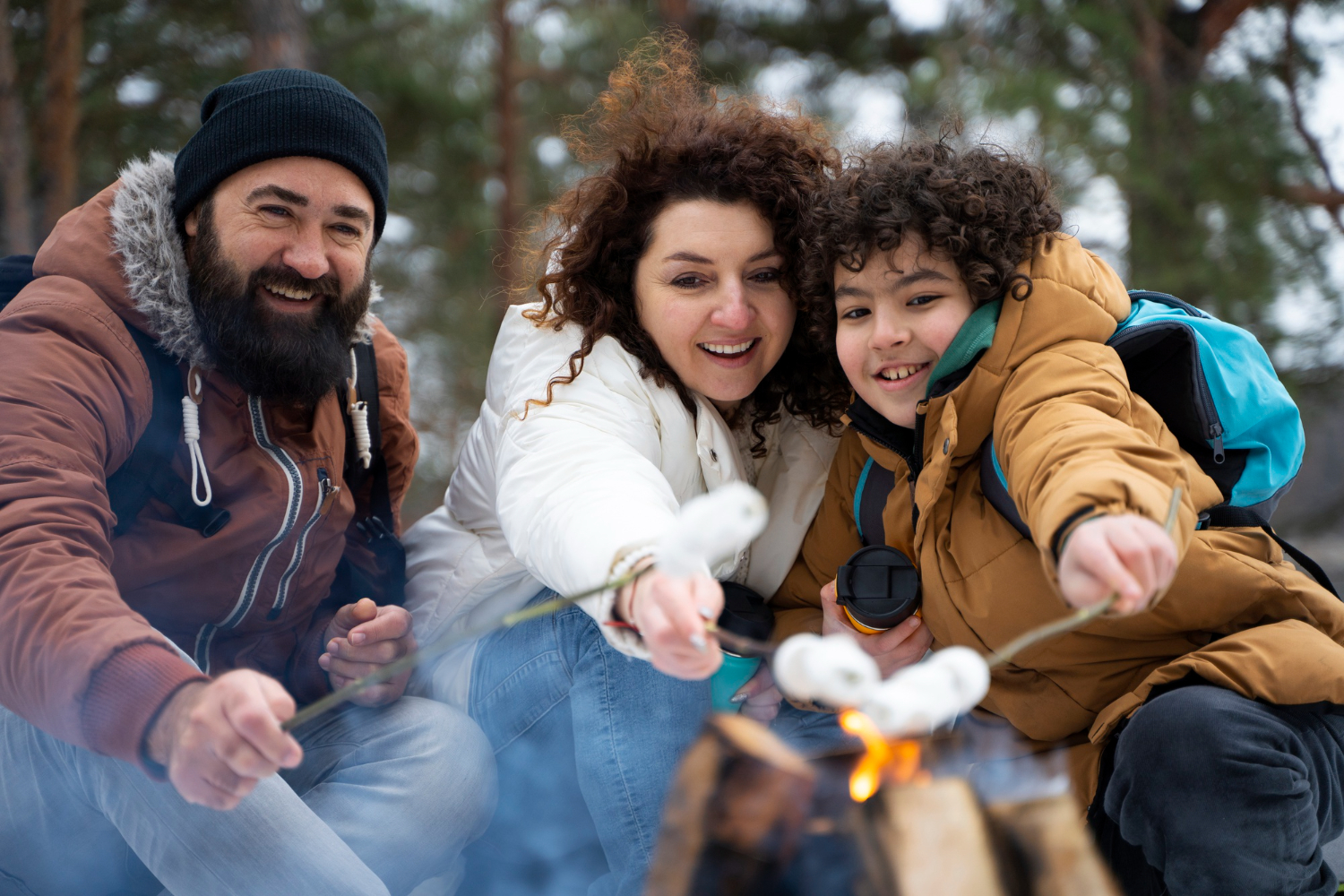 Family roasting marshmallows over a campfire in Colorado.