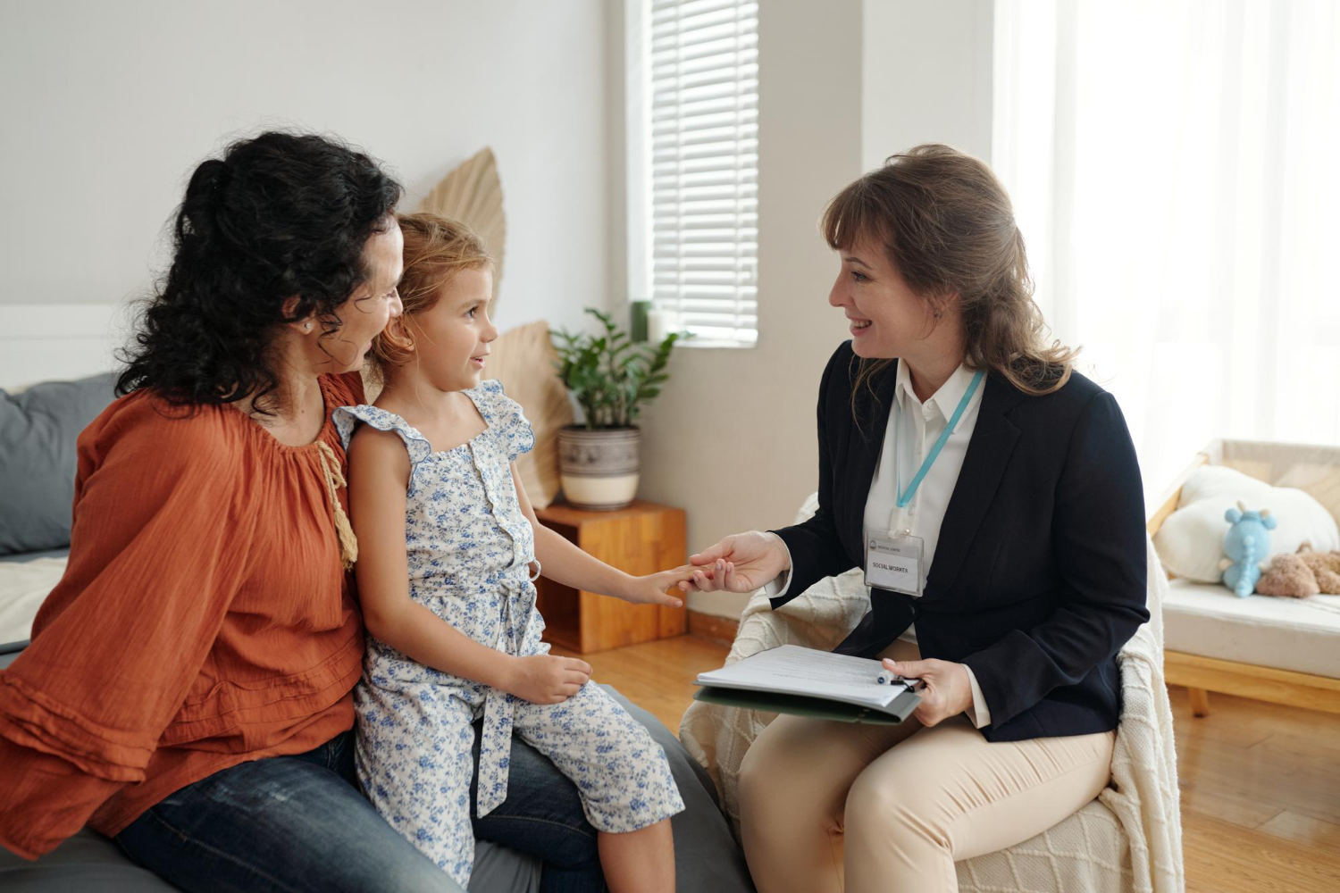 Mother and child meeting with ABA assessment provider at home.