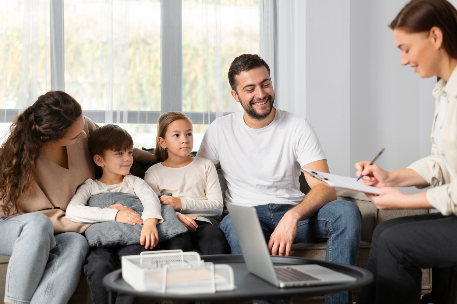 Family meeting with ABA therapist in home setting.