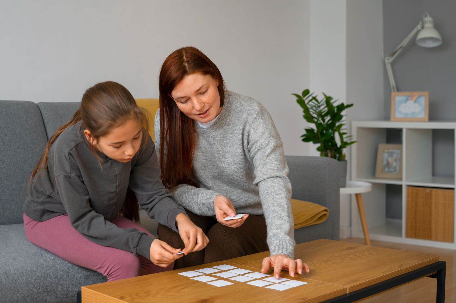 BCBA supporting a child with autism using picture cards during ABA therapy.