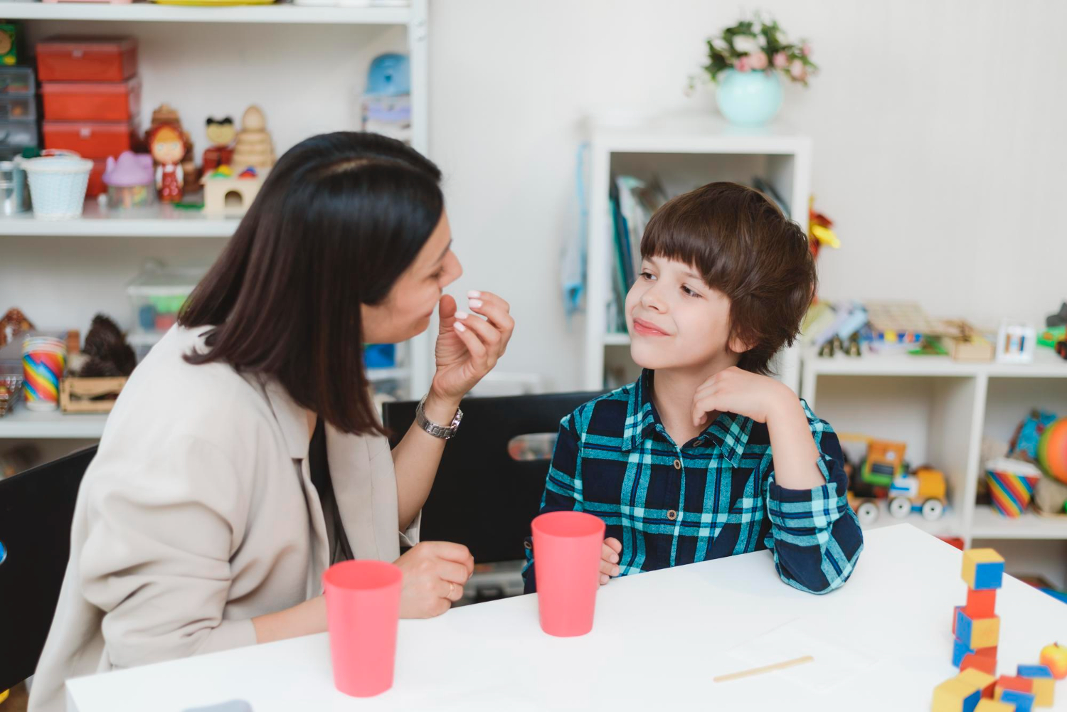 Therapist using ABA prompting with a child during a learning activity.