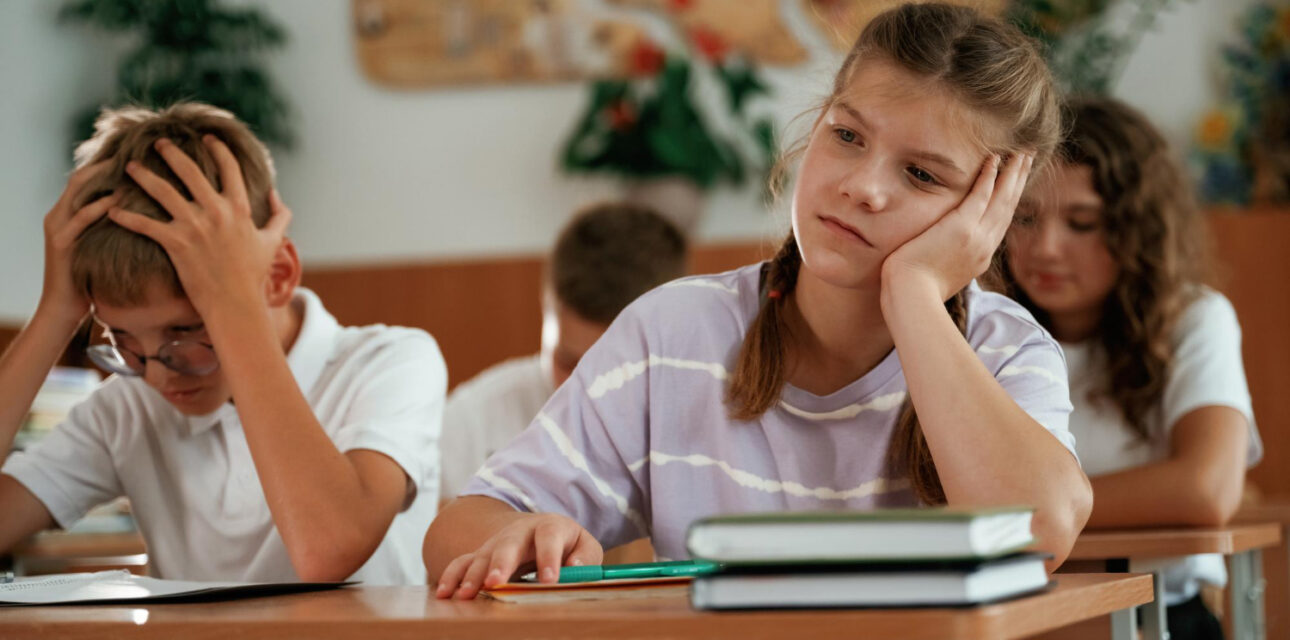 Child struggling to focus during a classroom lesson.