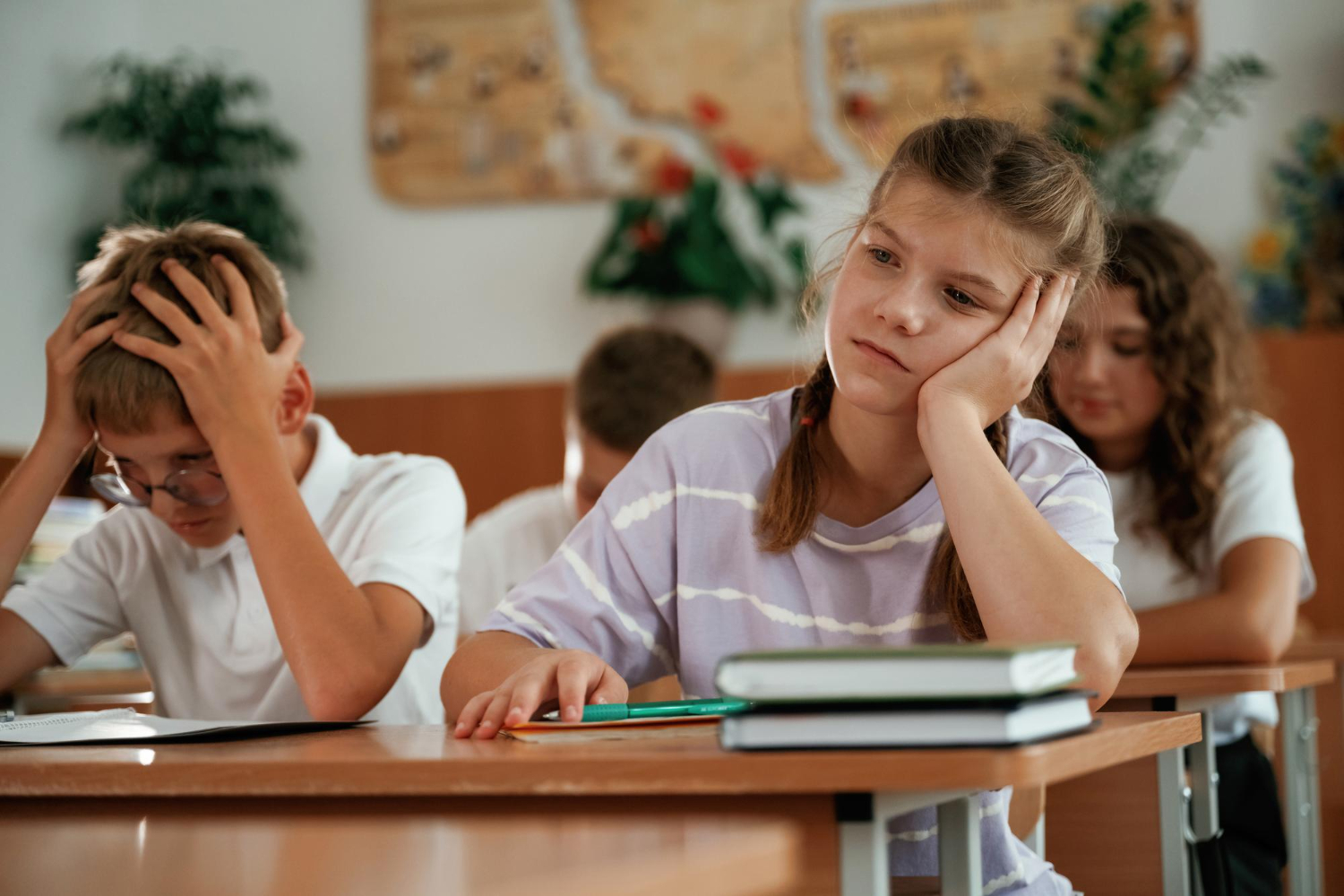 Child struggling to focus during a classroom lesson.