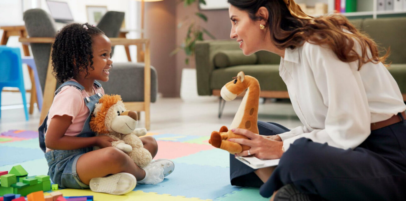 BCBA engaging an autistic child through play-based ABA therapy.