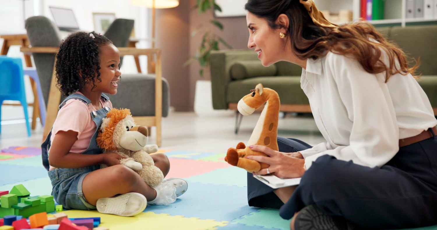 BCBA engaging an autistic child through play-based ABA therapy.