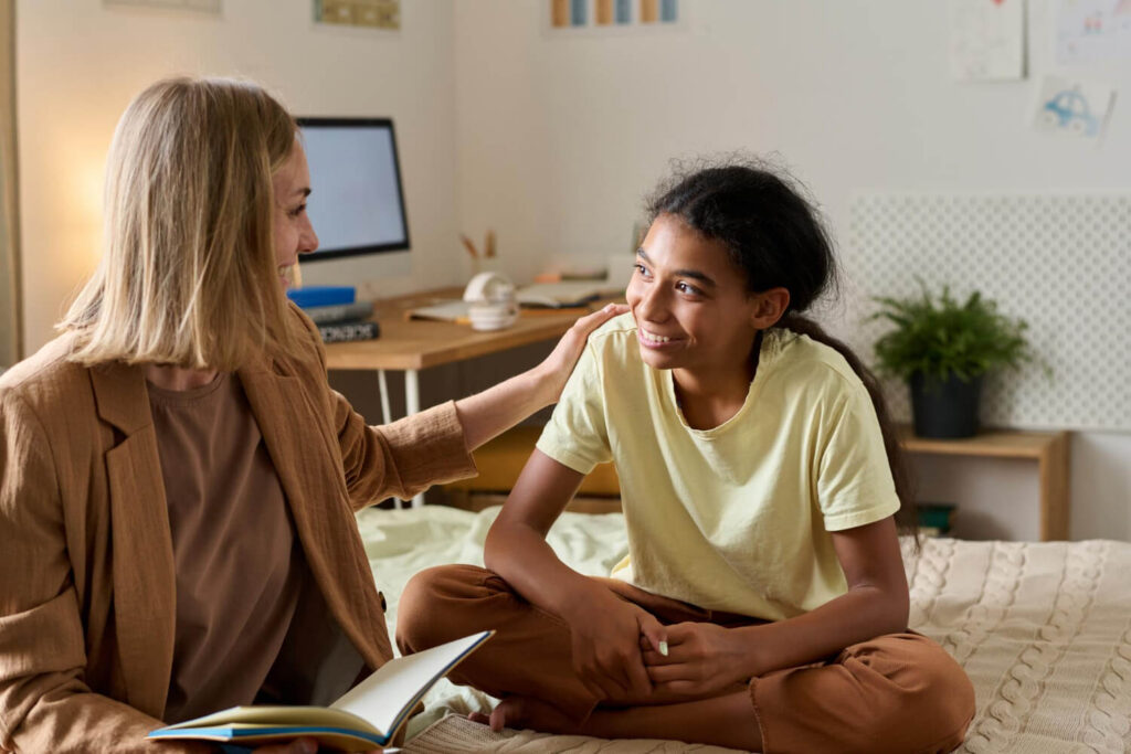 ABA therapist supporting an autistic teen during an at-home therapy session.