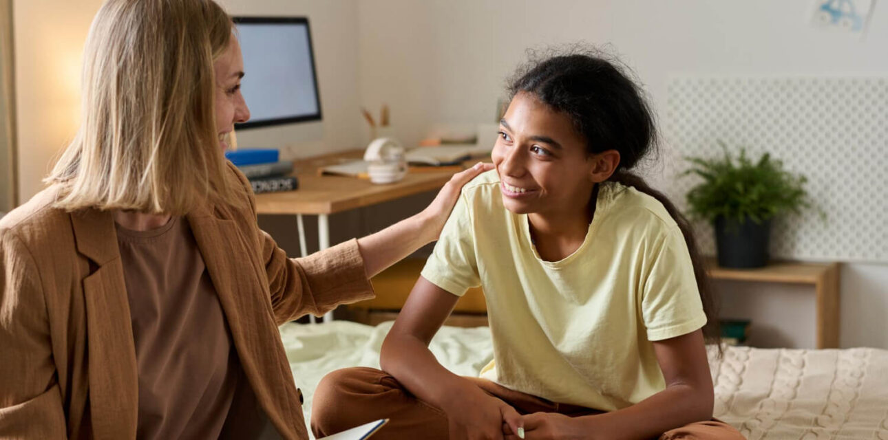 ABA therapist supporting an autistic teen during an at-home therapy session.