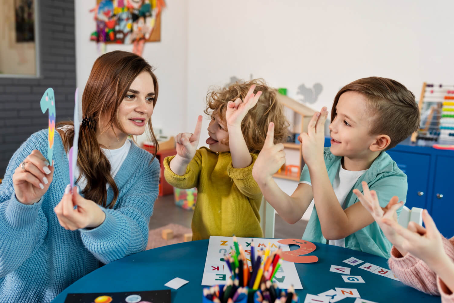 BCBA leading a hand-sign activity in an autism-friendly daycare.