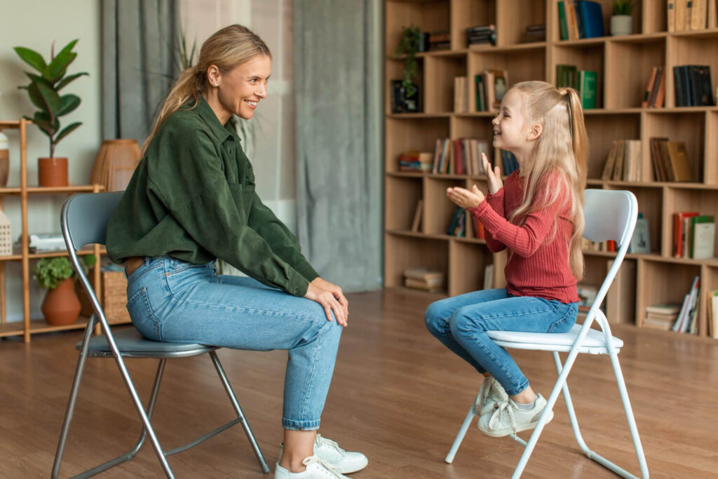BCBA engaging with a child with autism during an ABA therapy session in a comfortable home setting.