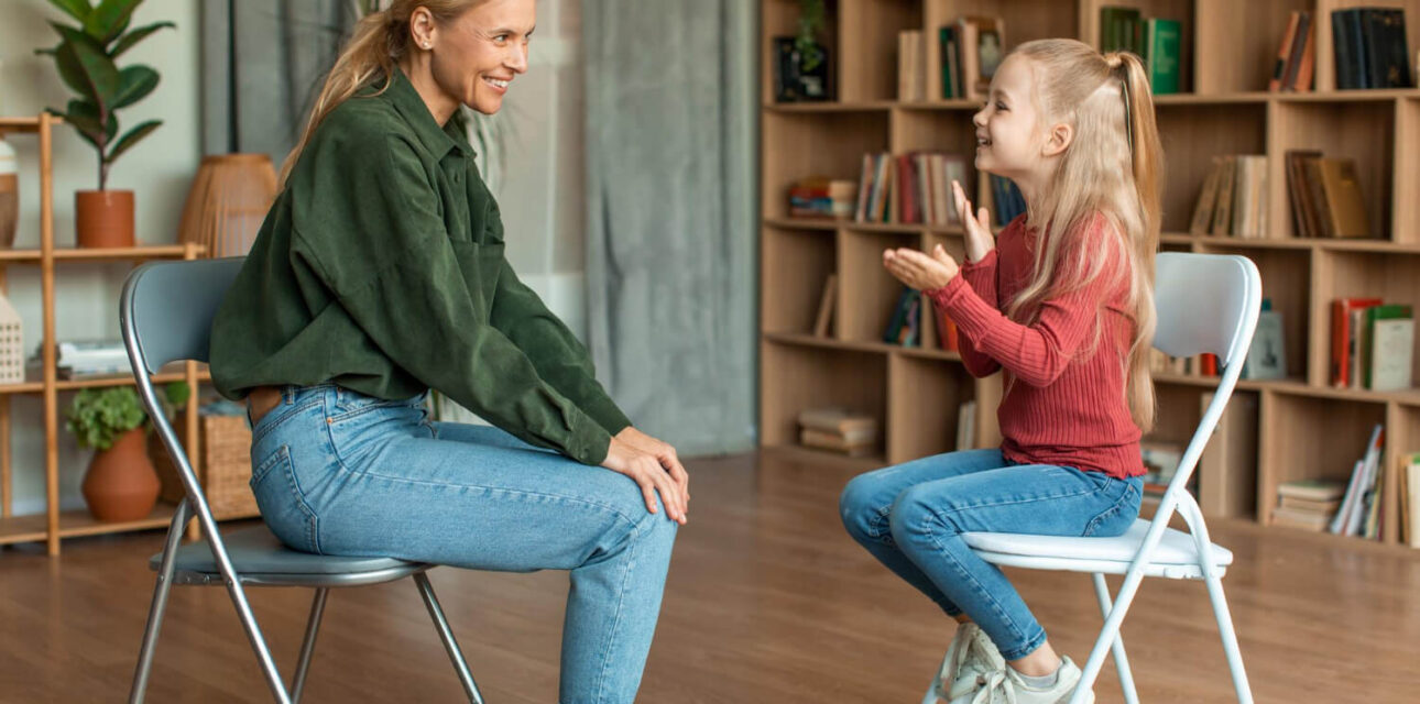 BCBA engaging with a child with autism during an ABA therapy session in a comfortable home setting.