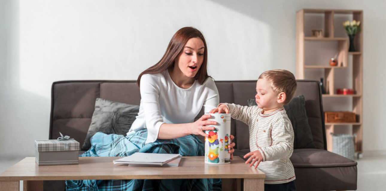 Autism babysitter playing with a young child at home.