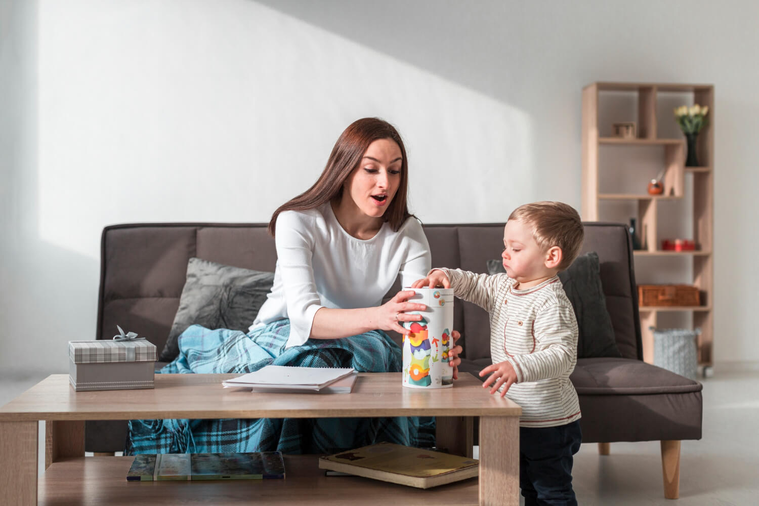 Autism babysitter playing with a young child at home.