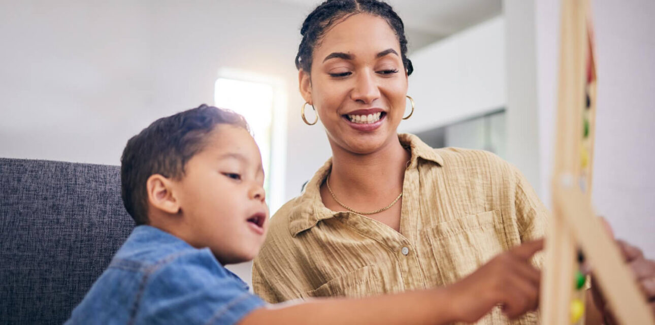 BCBA working with a child during an ABA therapy activity for autism support.