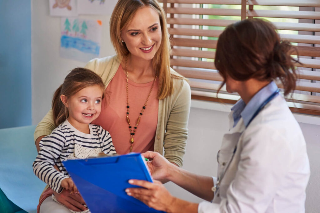 Mother and child speaking with a clinician during an autism assessment or ABA therapy consultation.