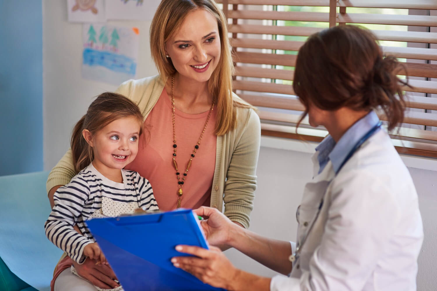 Mother and child speaking with a clinician during an autism assessment or ABA therapy consultation.