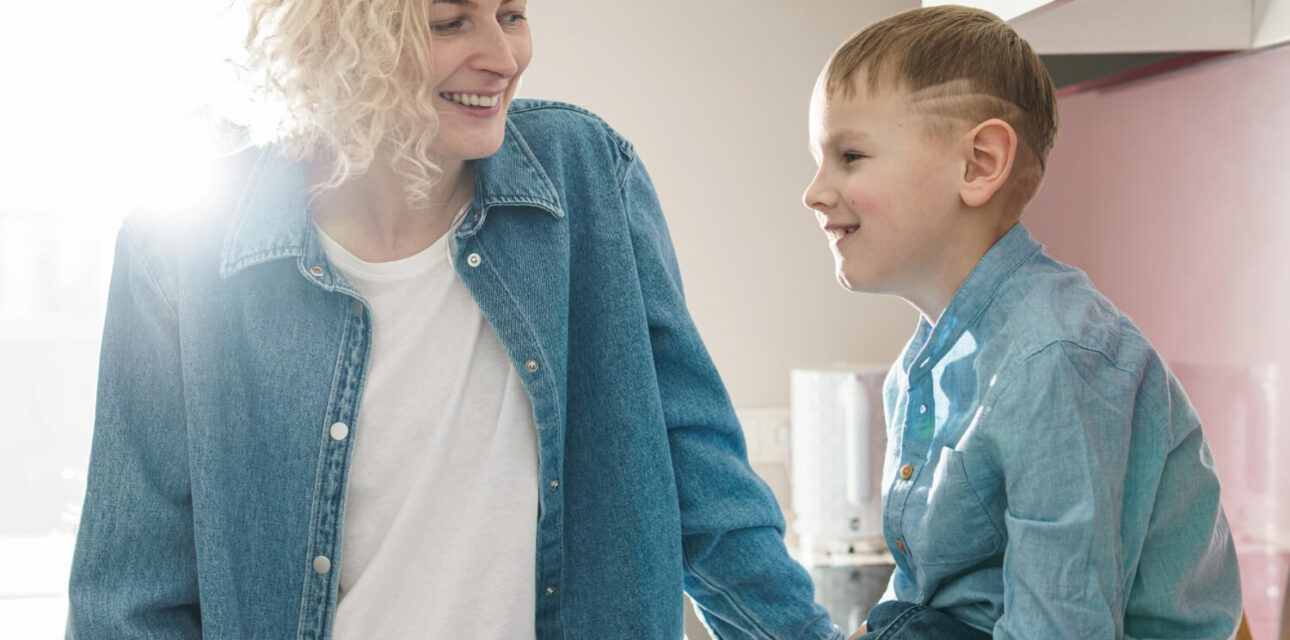 Mother and young boy making eye contact at home, illustrating autism and social interaction.