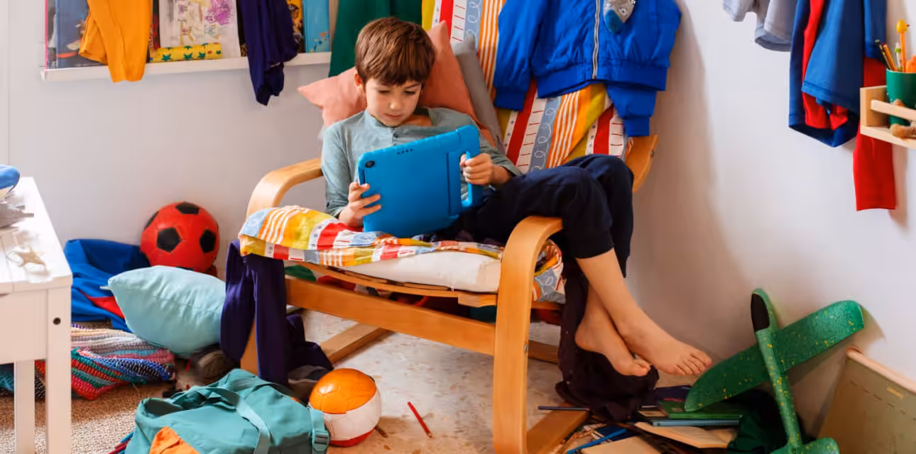 Autistic boy playing with his table in a bedroom.