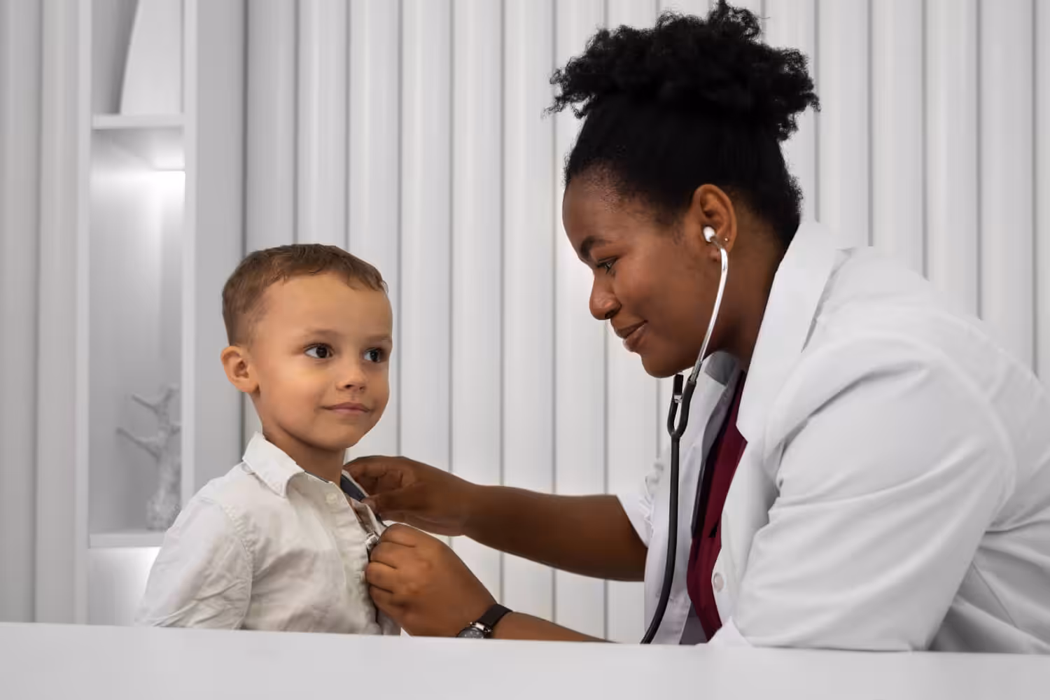 Doctor examining a young child with a stethoscope during a pediatric visit for an autism evaluation.